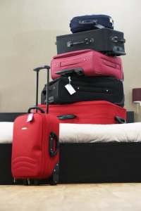 six suitcases stacked on top of each other