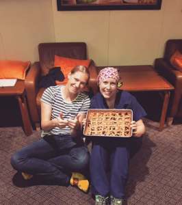 Mercy Ships: Silver Linings travel nurses holding a birthday pie while on assignment