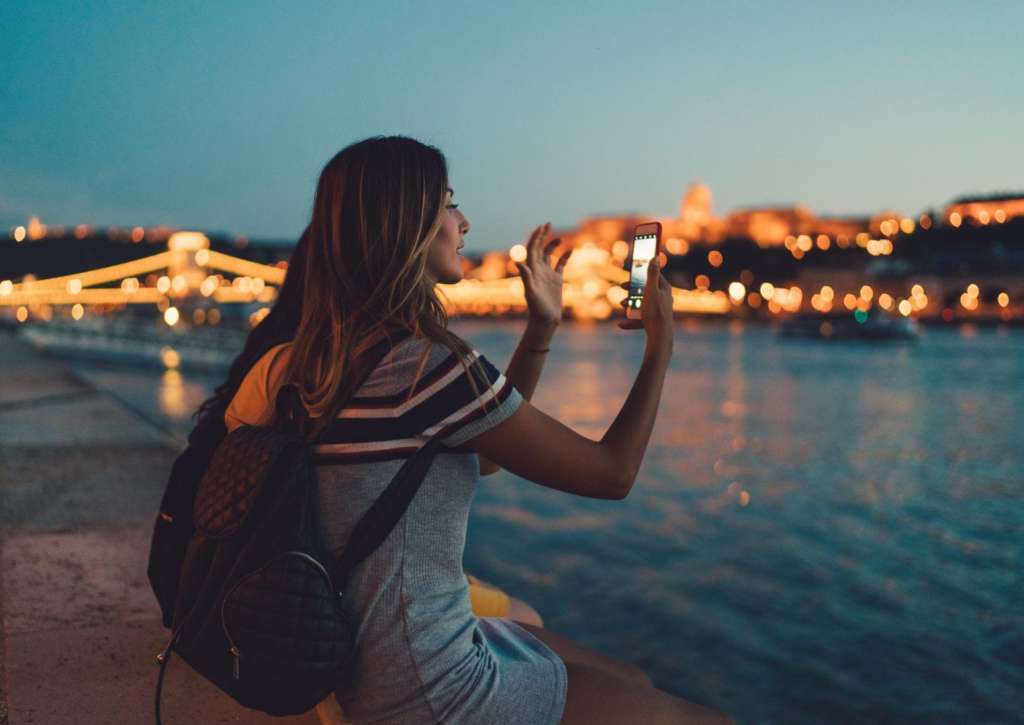 5 Valentine's Day Ideas for Travelers in a Long Distance Relationship Tourist in Budapest taking photos with smartphone