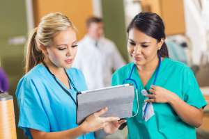 4 Ways to Spot a Traveler-Friendly Hospital Nurses consulting about patient chart with digital tablet in hospital