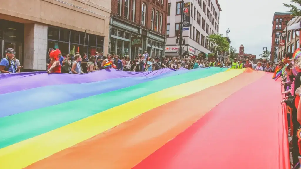 Portland Oregon Pride event with crowds celebrating, rainbow flags, and LGBTQ+ community gathering in downtown area.