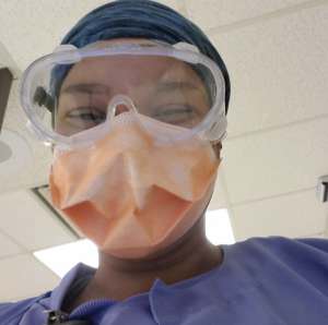 How to Be Safe As a Traveler (Follow These Tips) Chelsie in scrubs, mask, and eye protection