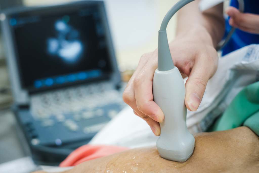 Echo Tech Career Guide: Salary, Schools, & Jobs Doctor is examining heart's patient by echocardiogram for diagnosis disease or explain symptom. Medical exam , ultrasound. Medical equipment.