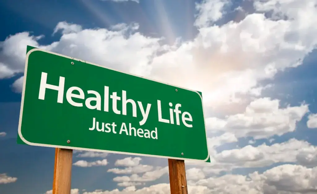 Healthy Life Green Road Sign Over Clouds