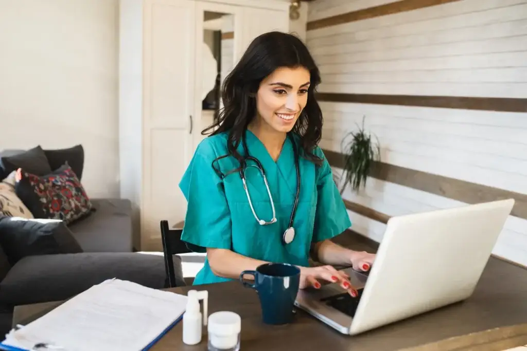 Young female doctor working online from home with her patients