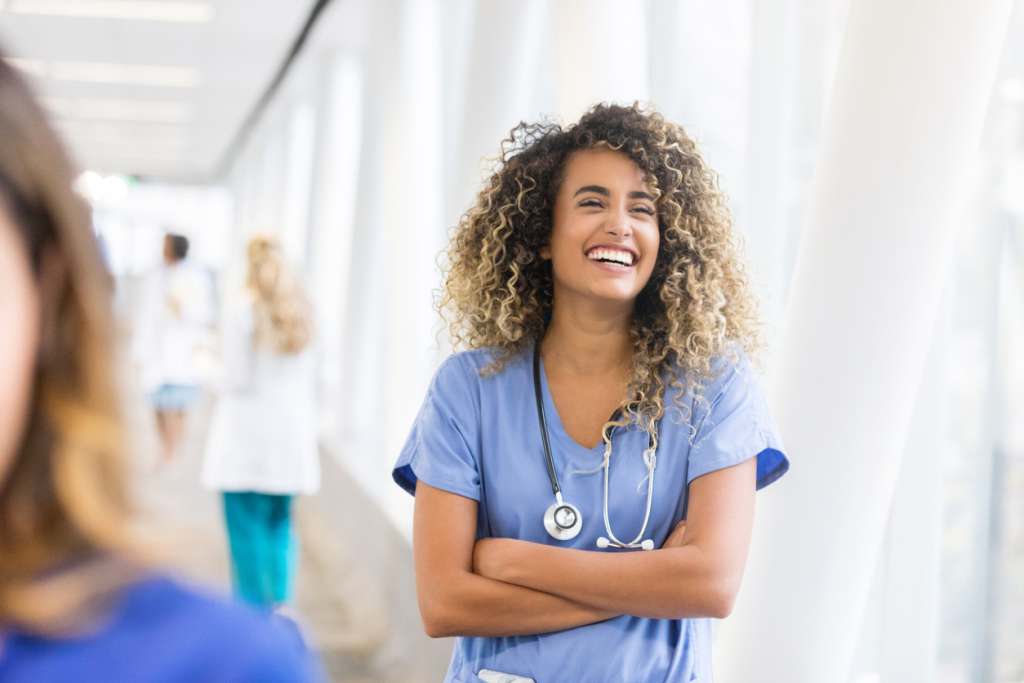 National Nurses Week 2023 Discounts Cheerful nurse in hospital skybridge