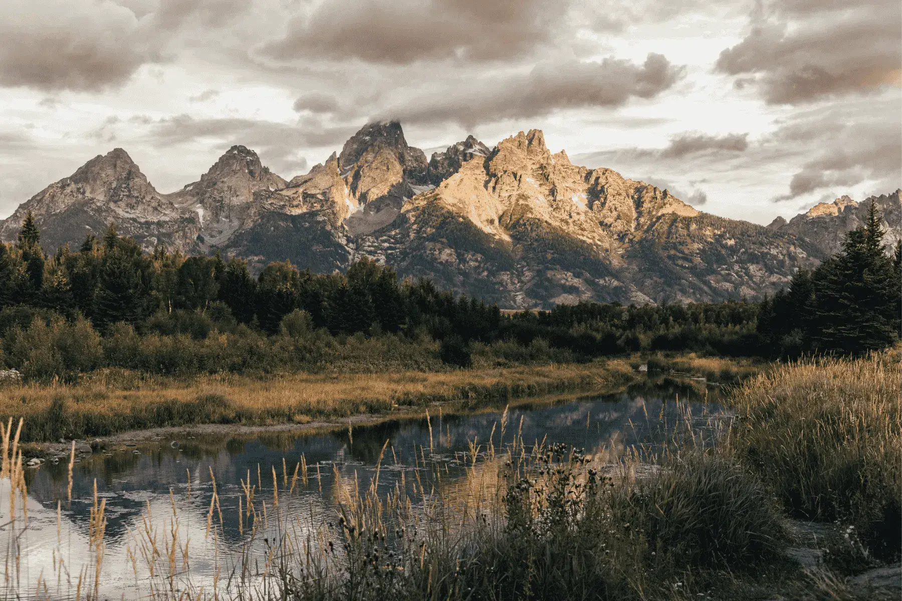 5 Mountainous National Parks and Top Hikes for the Best Views a view of a mountain range during sunrise with a river flowing below